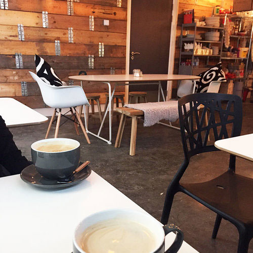 Fresh coffees on a table inside Nibble’s cosy café
